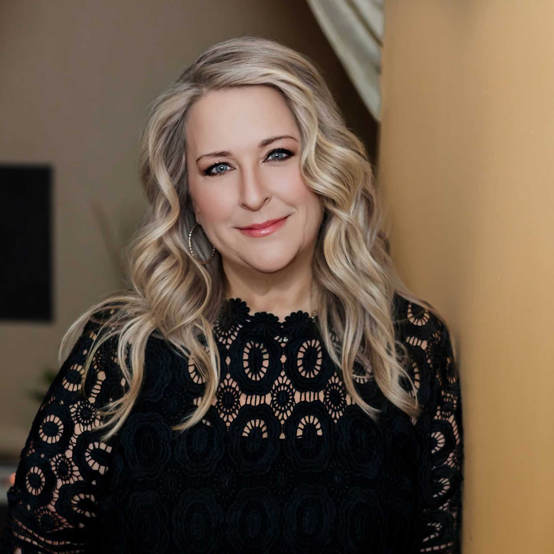Portrait of Sue, a professional stylist at Avanté Salon & Spa, showcasing their expertise and style.