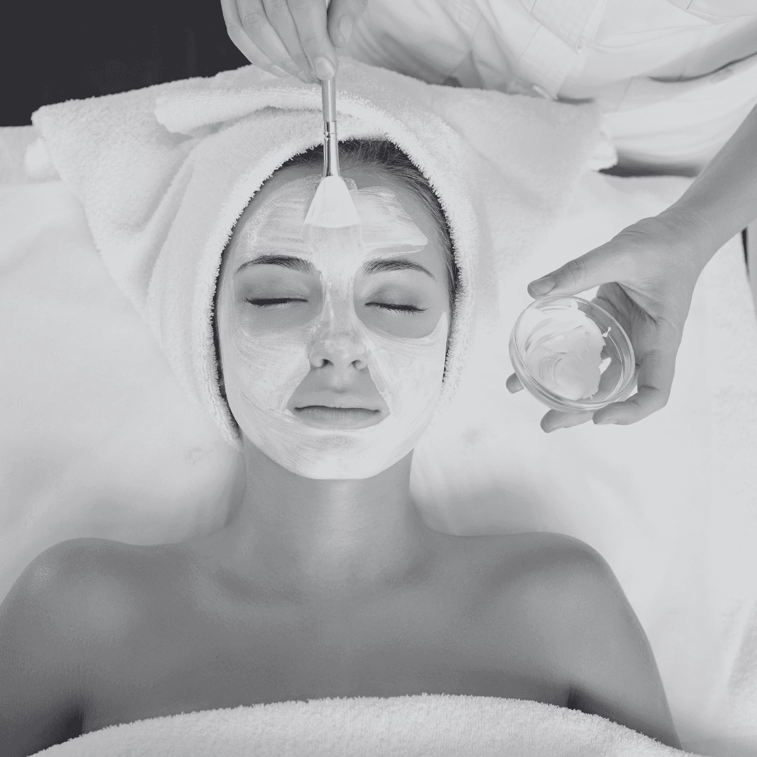 A woman receiving a relaxing facial treatment at a spa.