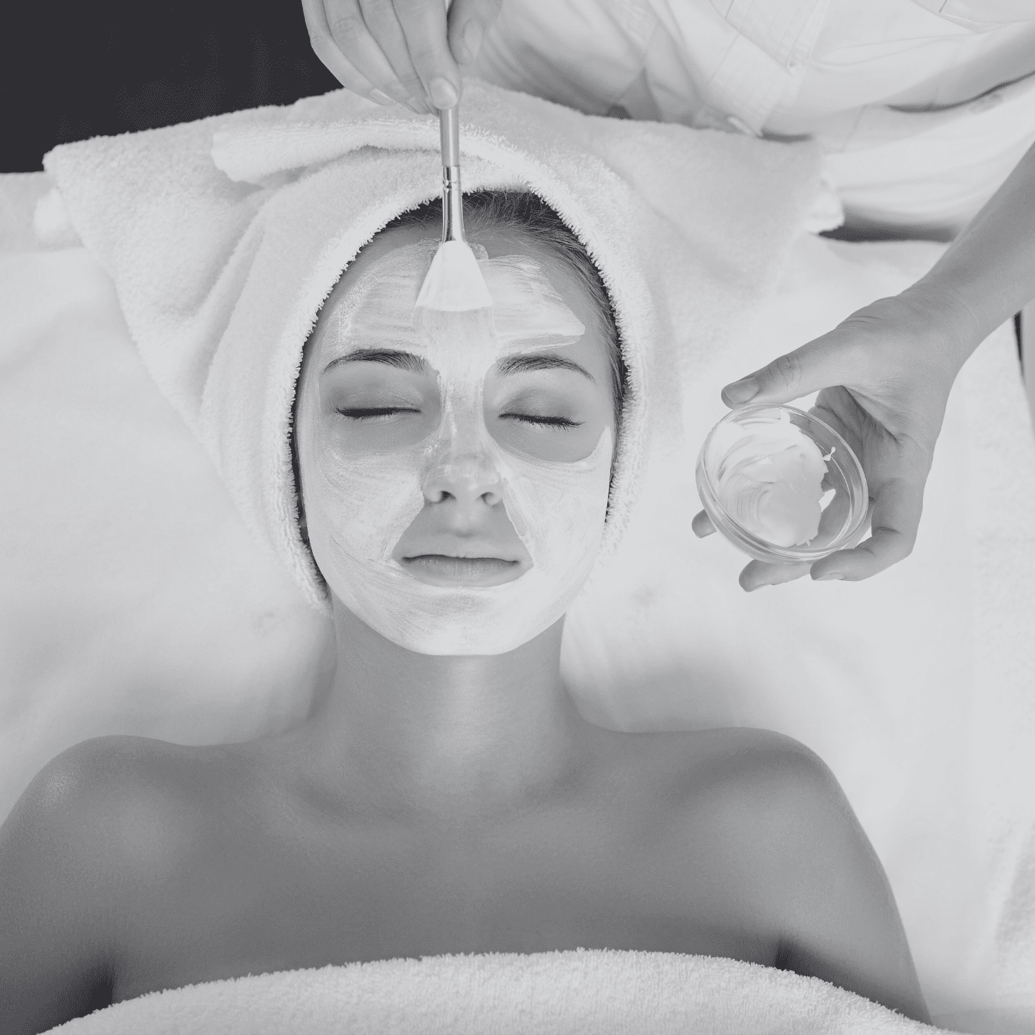 A woman receiving a relaxing facial treatment at a spa.